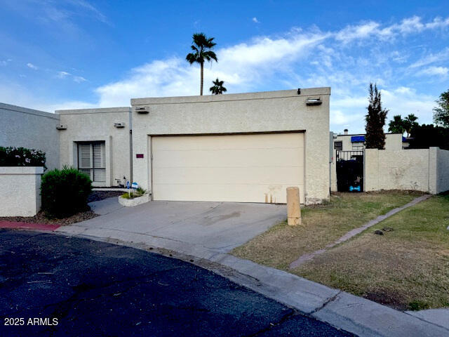 4727 E Euclid Ave, Phoenix, AZ 85044 - view of front of home with stucco siding, an attached garage, and driveway