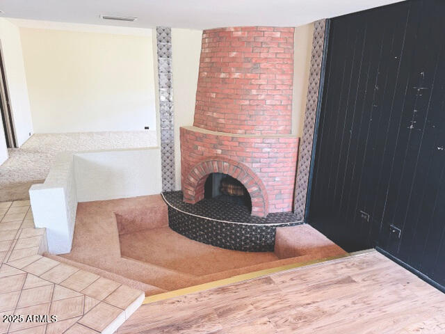 4727 E Euclid Ave, Phoenix, AZ 85044 - living room featuring a fireplace and wood finished floors