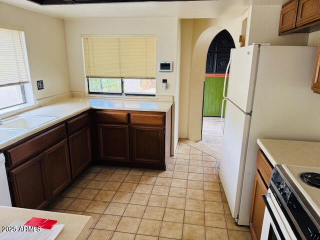 4727 E Euclid Ave, Phoenix, AZ 85044 - kitchen featuring electric stove, light countertops, healthy amount of natural light, and light tile patterned floors