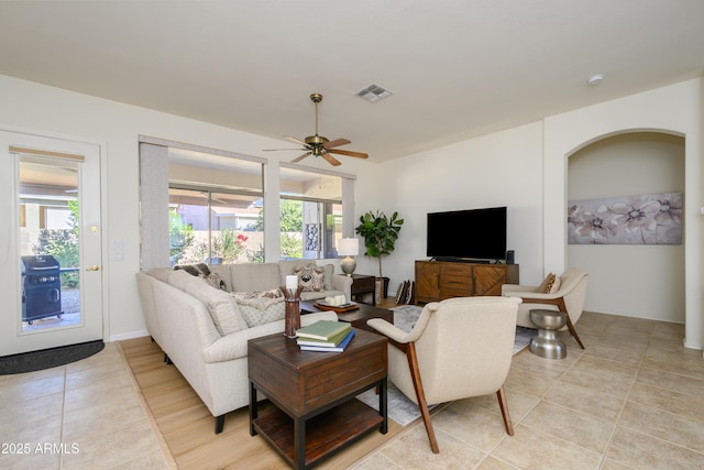 living room featuring ceiling fan and light tile patterned floors