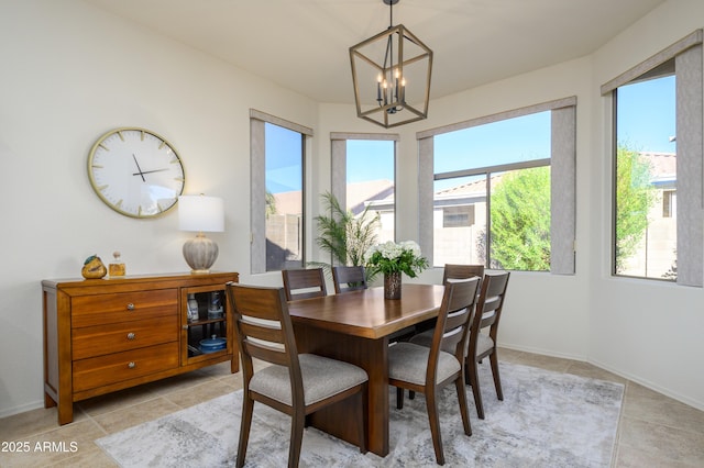 tiled dining room featuring plenty of natural light and an inviting chandelier