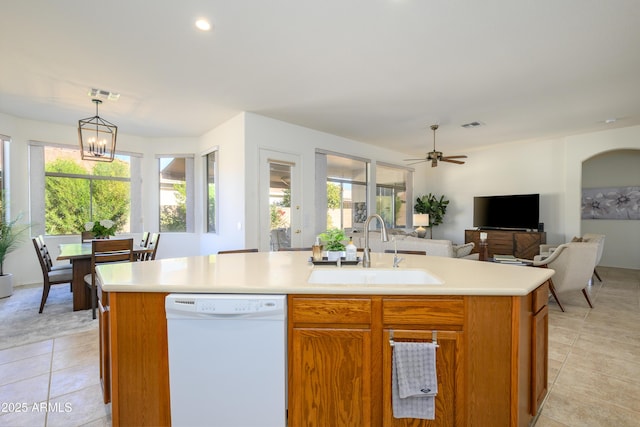 kitchen with dishwasher, decorative light fixtures, an island with sink, sink, and light tile patterned flooring