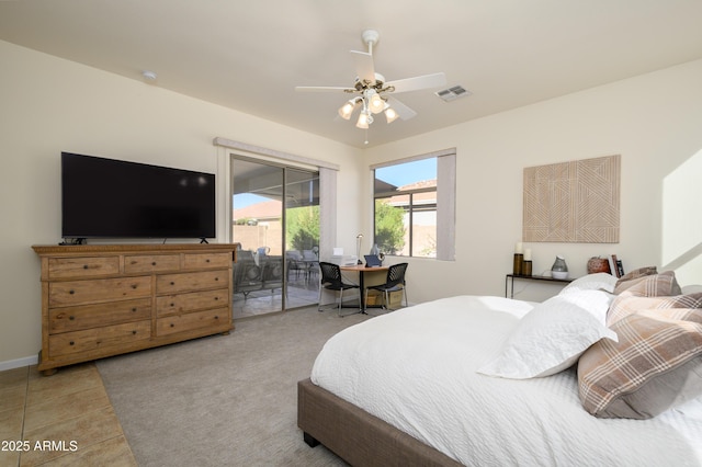 bedroom featuring access to outside, ceiling fan, and tile patterned floors