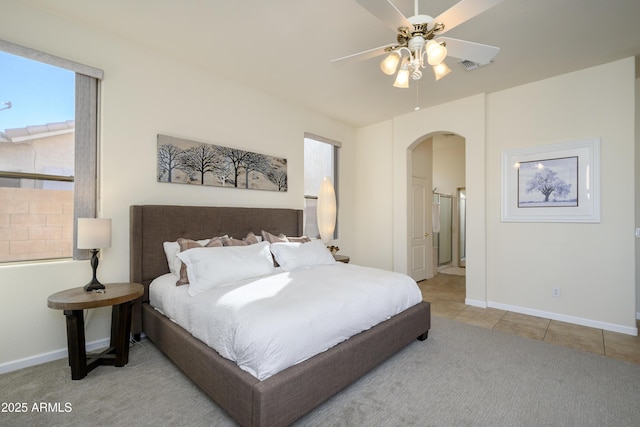 tiled bedroom featuring ceiling fan