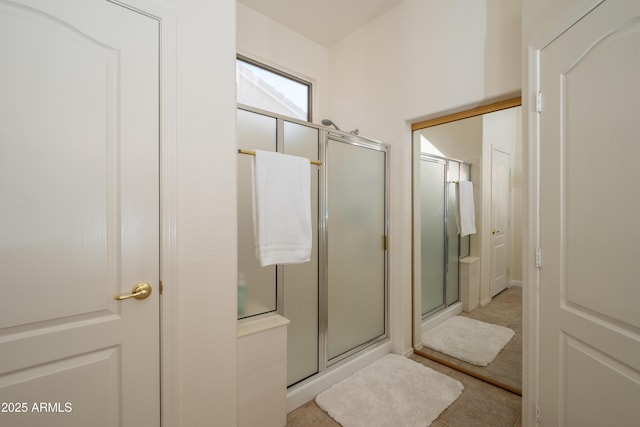 bathroom featuring tile patterned floors and a shower with door