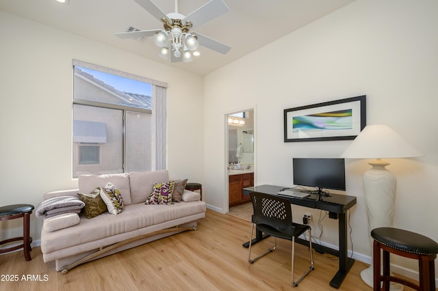 office space featuring ceiling fan, light wood-type flooring, and lofted ceiling