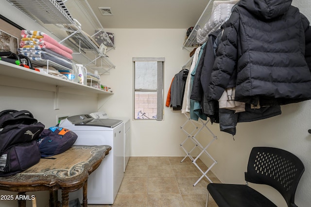 clothes washing area featuring separate washer and dryer and light tile patterned floors