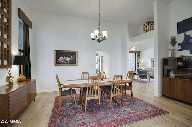 1750 E Mallory St, Mesa, AZ 85203 - dining space with a chandelier, light wood-style flooring, a towering ceiling, and a ceiling fan