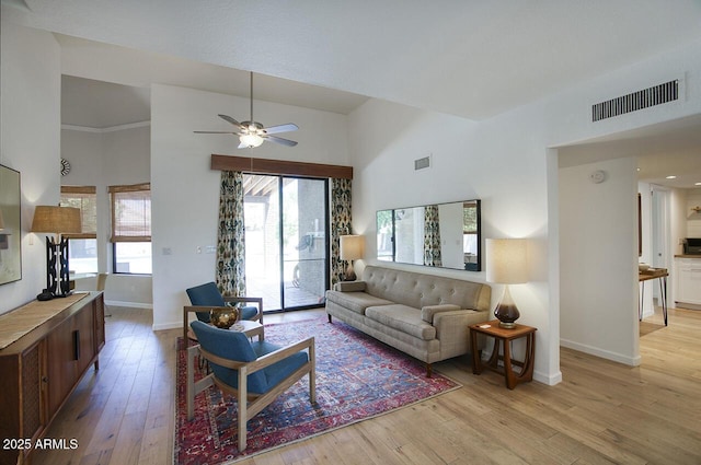 1750 E Mallory St, Mesa, AZ 85203 - living room featuring a towering ceiling, healthy amount of natural light, light wood-style flooring, and ceiling fan