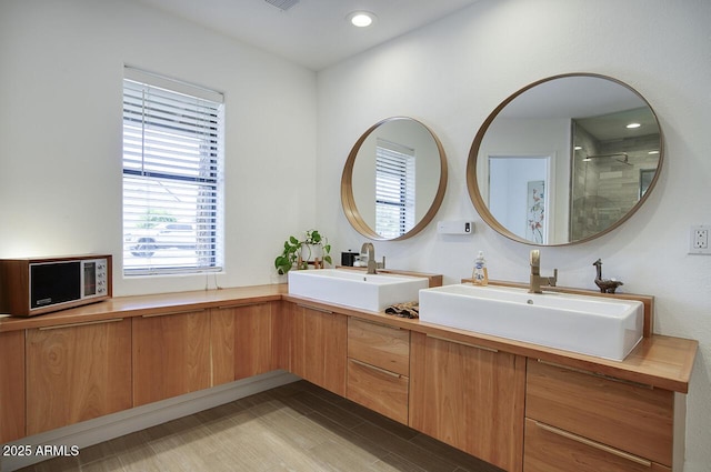 1750 E Mallory St, Mesa, AZ 85203 - full bath with double vanity, tiled shower, wood finished floors, and recessed lighting