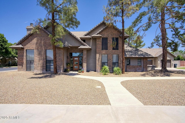 1750 E Mallory St, Mesa, AZ 85203 - view of front facade with a chimney, brick siding, and a tiled roof
