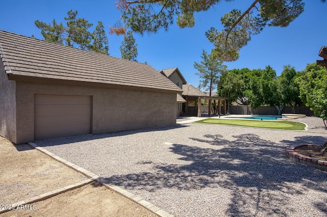 1750 E Mallory St, Mesa, AZ 85203 - view of property exterior featuring stucco siding, a pool, and a tile roof