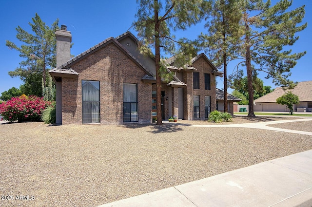 1750 E Mallory St, Mesa, AZ 85203 - view of front of home with a tiled roof, a chimney, and brick siding