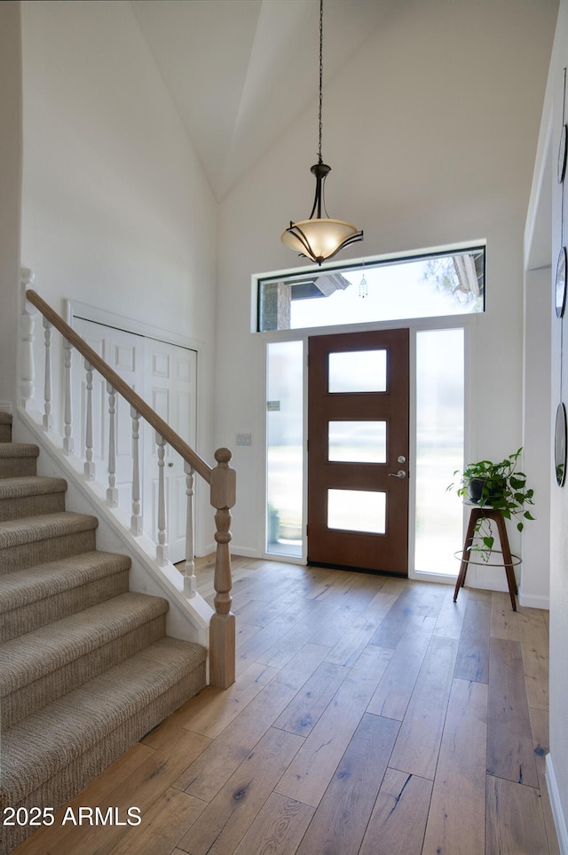 1750 E Mallory St, Mesa, AZ 85203 - foyer entrance with high vaulted ceiling, stairway, and hardwood / wood-style floors