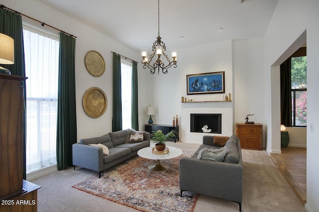 1750 E Mallory St, Mesa, AZ 85203 - living room featuring carpet, a chandelier, a fireplace with flush hearth, and healthy amount of natural light