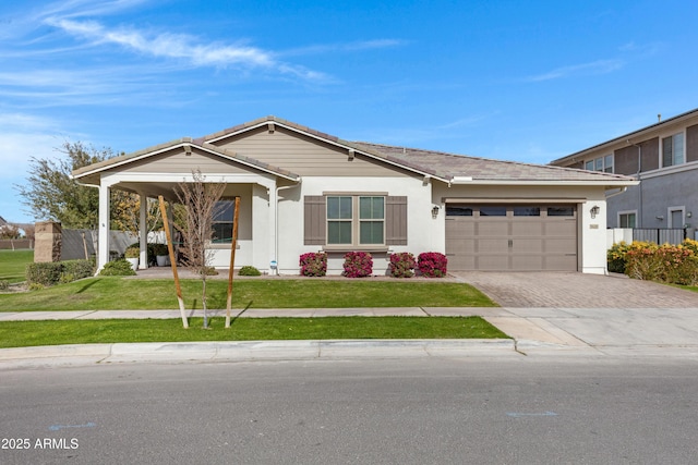 view of front of property with a garage and a front lawn