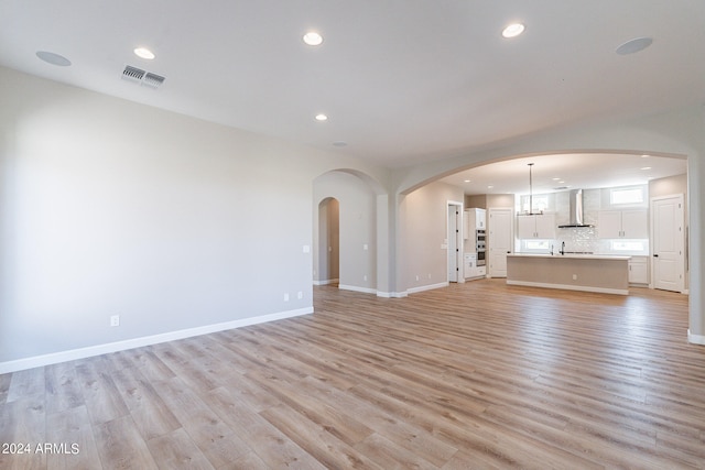 unfurnished living room with light hardwood / wood-style flooring