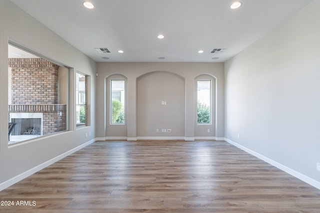 entryway featuring a brick fireplace and hardwood / wood-style floors