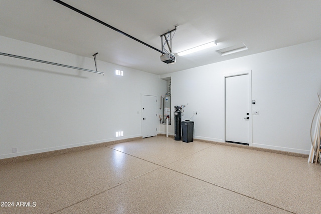 garage featuring a garage door opener and water heater