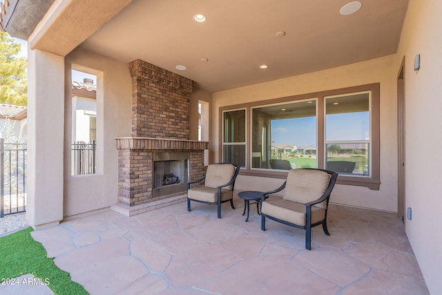 view of patio with an outdoor brick fireplace