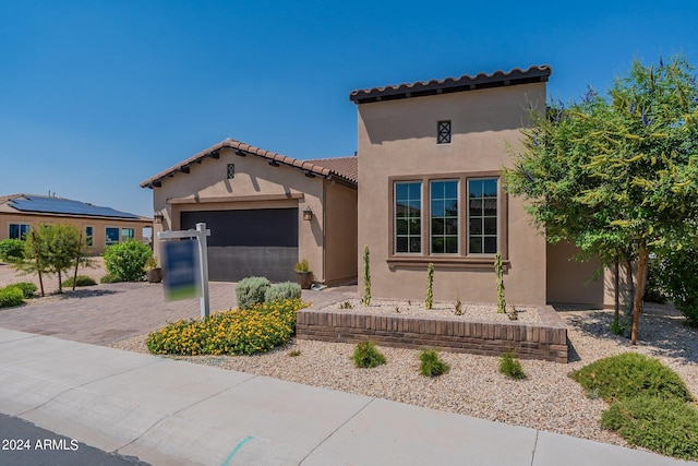 mediterranean / spanish-style home featuring a garage