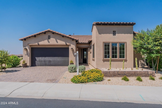 mediterranean / spanish-style home with a garage