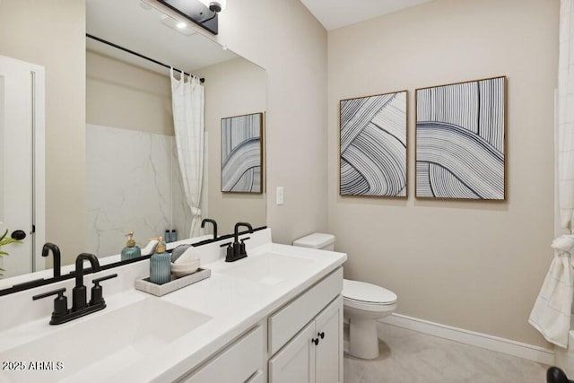 bathroom featuring vanity, curtained shower, and toilet