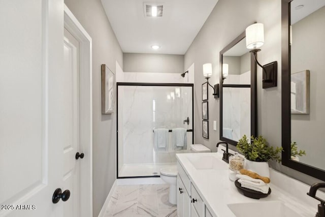 bathroom featuring walk in shower, vanity, and toilet