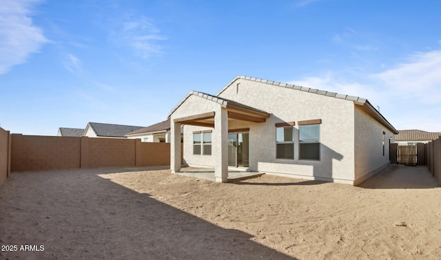 back of house with a patio