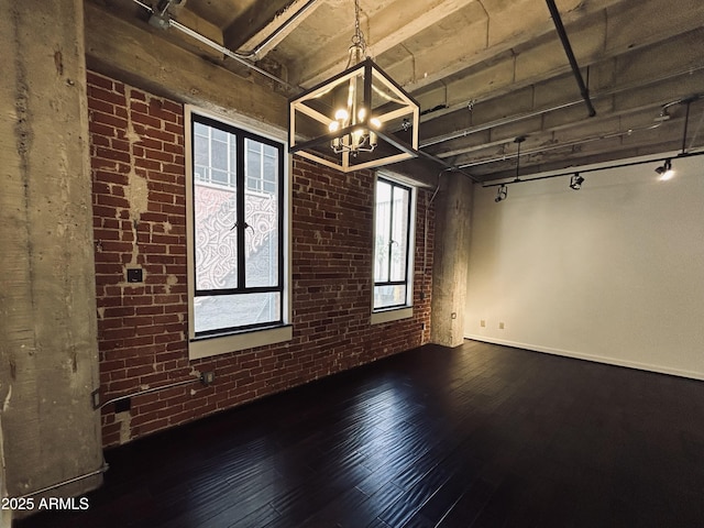 114 W Adams St Unit 302, Phoenix, AZ 85003 - empty room featuring brick wall, a chandelier, and wood-type flooring
