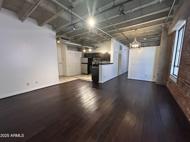 114 W Adams St Unit 302, Phoenix, AZ 85003 - unfurnished living room featuring wood finished floors, baseboards, and a chandelier