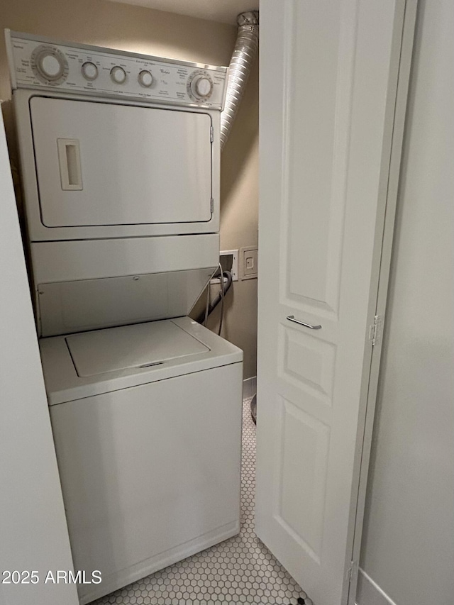114 W Adams St Unit 302, Phoenix, AZ 85003 - washroom featuring stacked washer / dryer and light tile patterned flooring
