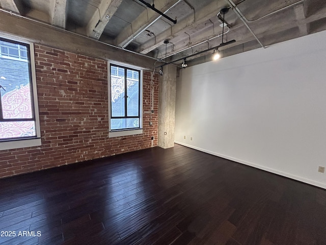 114 W Adams St Unit 302, Phoenix, AZ 85003 - unfurnished room with brick wall, wood finished floors, and baseboards