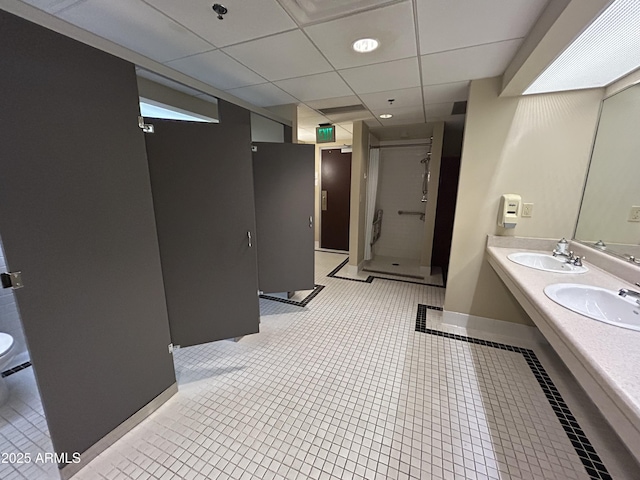 114 W Adams St Unit 302, Phoenix, AZ 85003 - bathroom with a shower stall, double vanity, tile patterned floors, a paneled ceiling, and baseboards