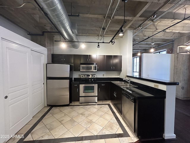 114 W Adams St Unit 302, Phoenix, AZ 85003 - kitchen with stainless steel appliances, dark countertops, a sink, dark cabinets, and light tile patterned floors