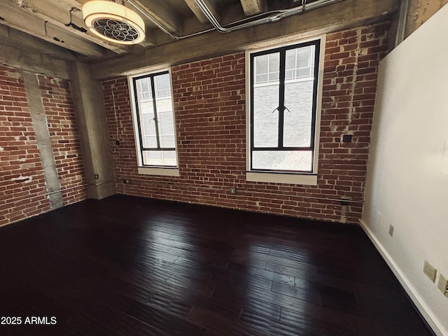 114 W Adams St Unit 302, Phoenix, AZ 85003 - empty room with brick wall, wood-type flooring, and plenty of natural light