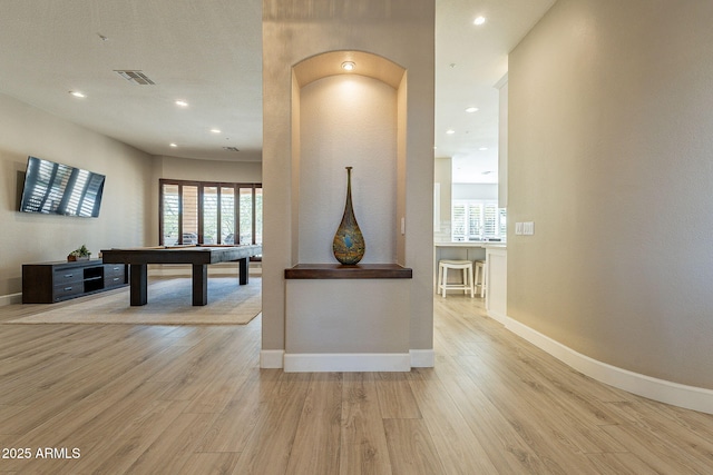 interior space featuring visible vents, baseboards, and wood finished floors