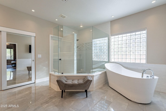 bathroom featuring visible vents, a healthy amount of sunlight, and marble finish floor