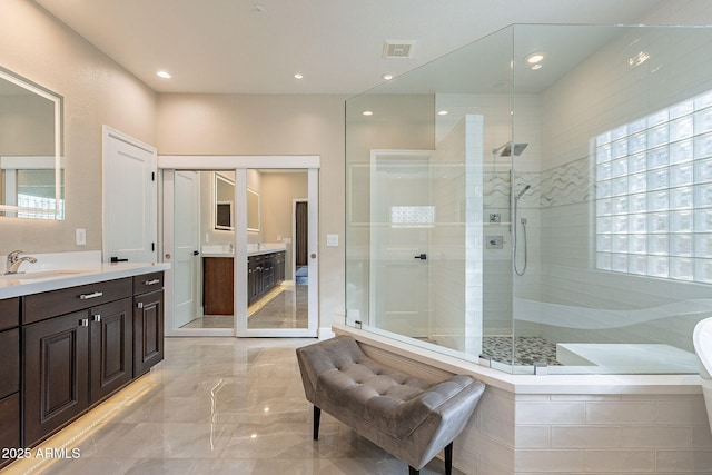 bathroom featuring vanity, recessed lighting, marble finish floor, and a stall shower