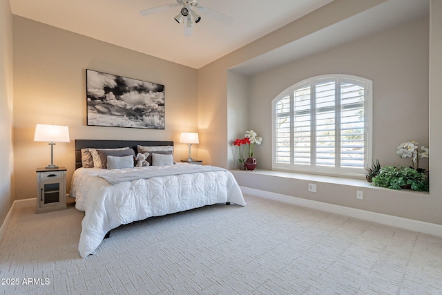 carpeted bedroom featuring a ceiling fan and baseboards