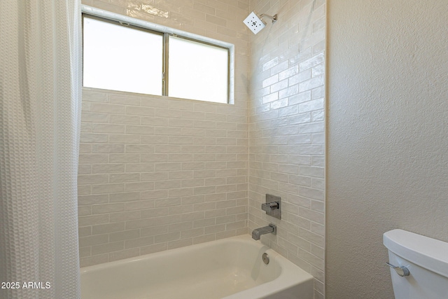 full bath with shower / bathtub combination with curtain, toilet, and a textured wall