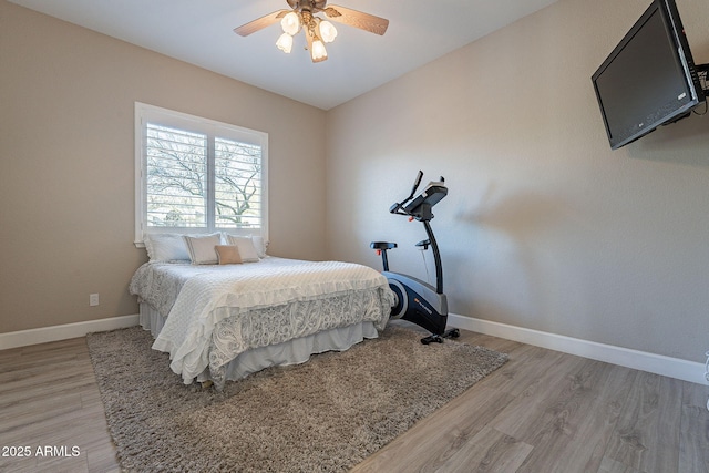 bedroom with ceiling fan, light wood-type flooring, and baseboards