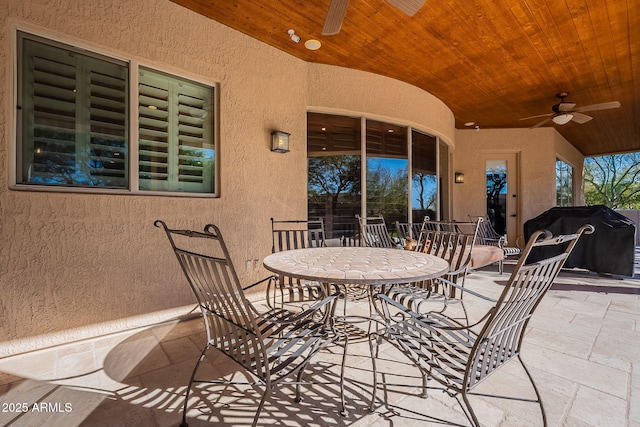 view of patio featuring outdoor dining space, a grill, and ceiling fan