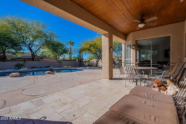 view of patio featuring ceiling fan, a fenced in pool, and a fenced backyard