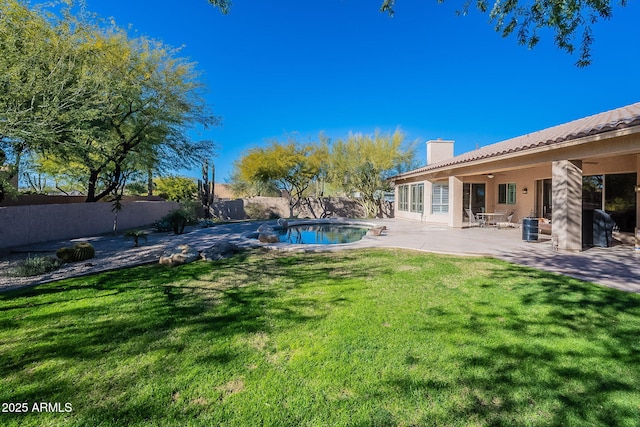 view of yard with a fenced in pool, a patio, a fenced backyard, and ceiling fan