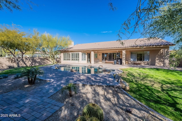 rear view of property with a patio, a lawn, a chimney, and fence