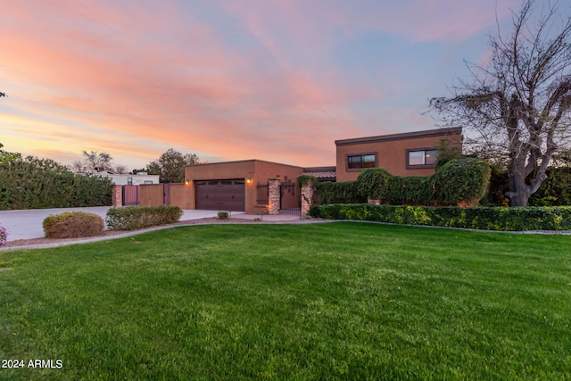 view of front of property with a yard and a garage