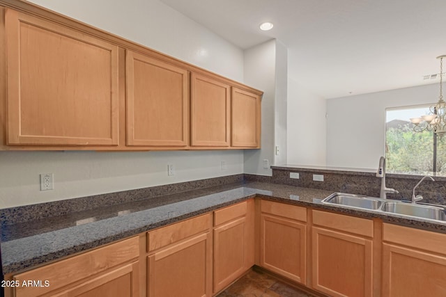 16600 N Thompson Peak Pkwy Unit 1072, Scottsdale, AZ 85260 - kitchen with a sink, dark stone countertops, visible vents, recessed lighting, and an inviting chandelier