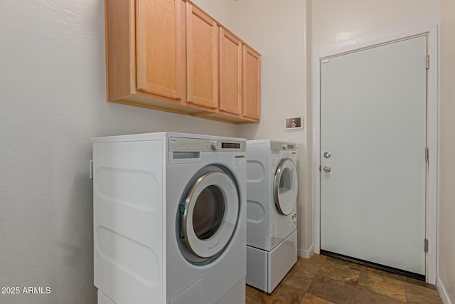 16600 N Thompson Peak Pkwy Unit 1072, Scottsdale, AZ 85260 - washroom featuring washing machine and dryer, stone finish floor, and cabinet space
