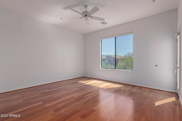 16600 N Thompson Peak Pkwy Unit 1072, Scottsdale, AZ 85260 - spare room with baseboards, visible vents, a ceiling fan, and wood finished floors